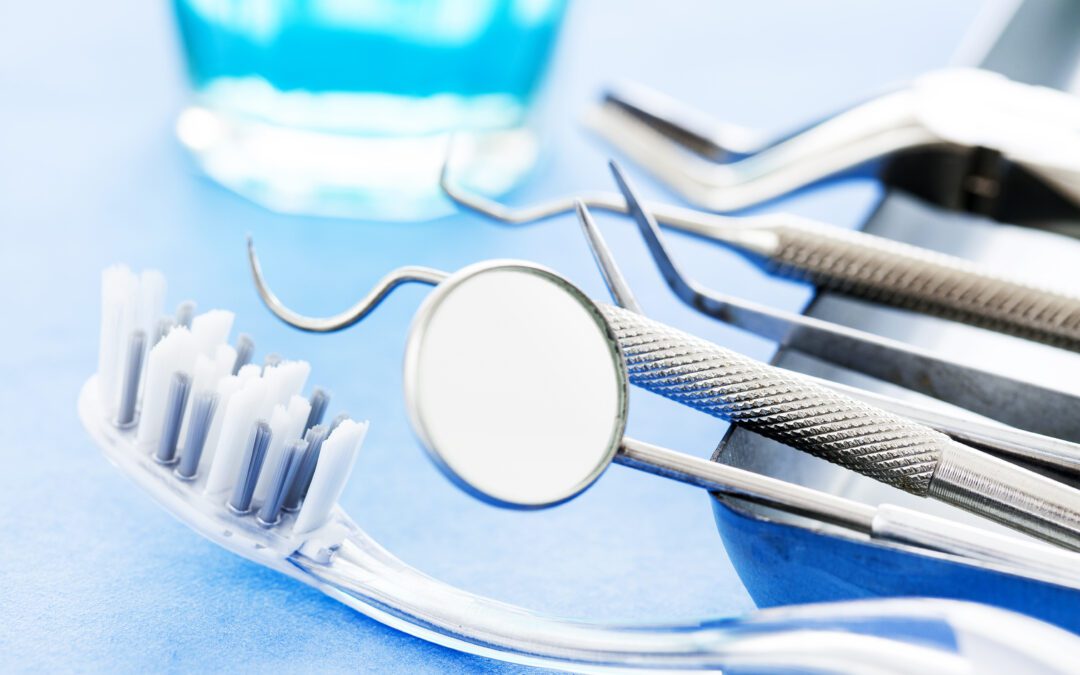 a close up photo of dental tools and a toothbrush